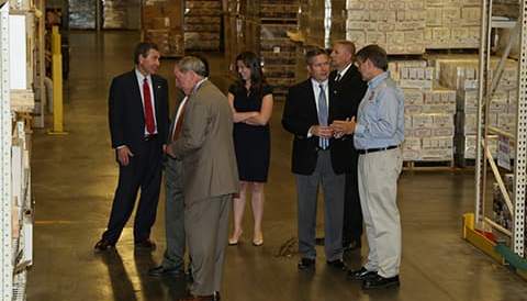 Group of people meeting on warehouse floor